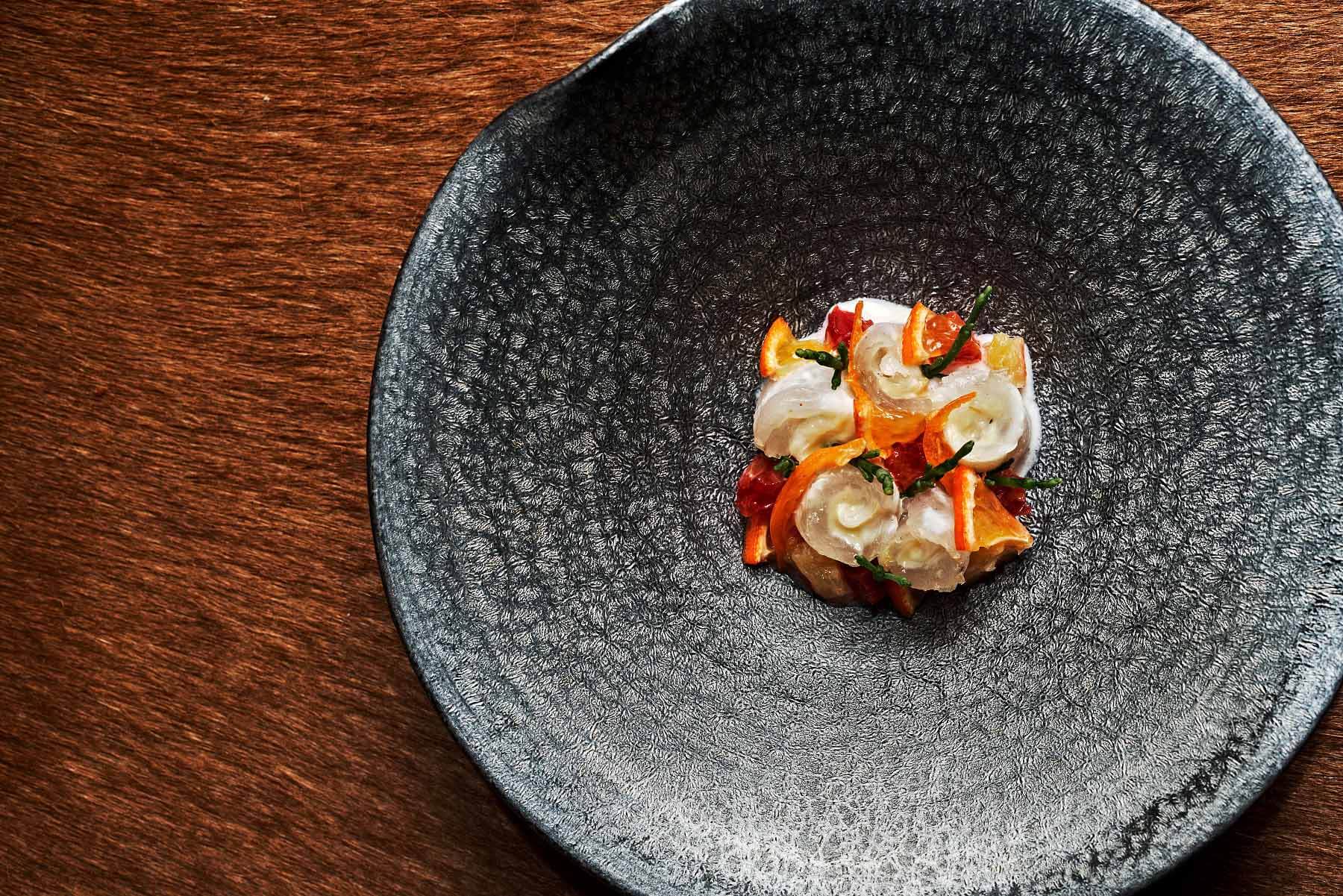 Black dish with entrée from The Catbird Seat