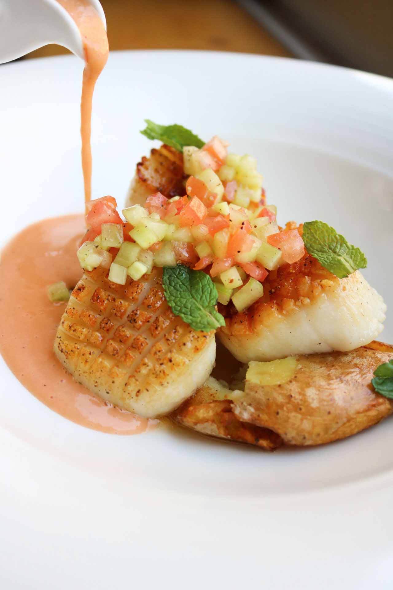 The vegetable relish accompanying this scallop dish demonstrates from seriously talented knifework. Image: CAMP Sea scallops from CAMP Modern American Eatery, a new Southern restaurant