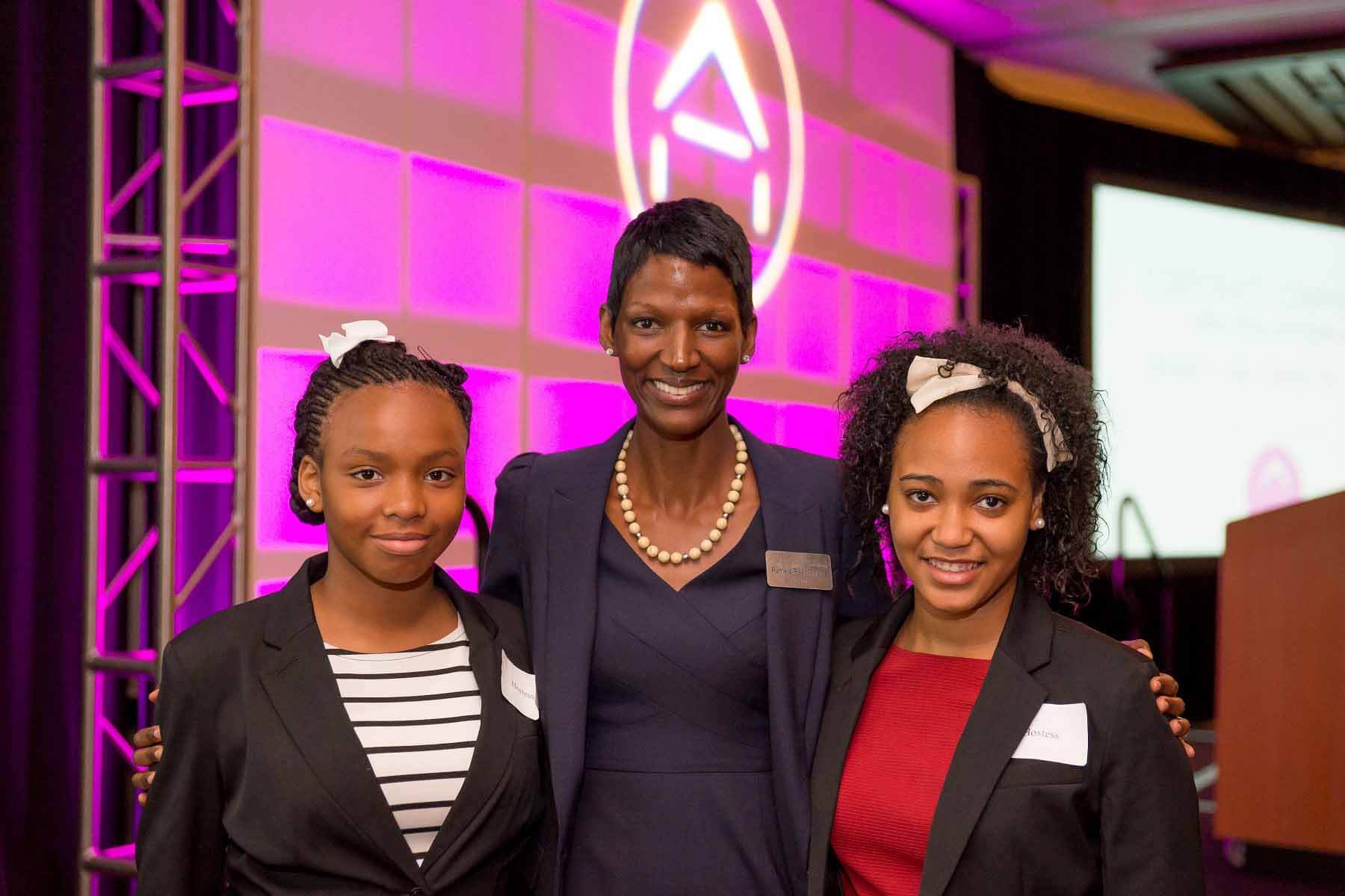 Pamela posing with two former Grace House residents