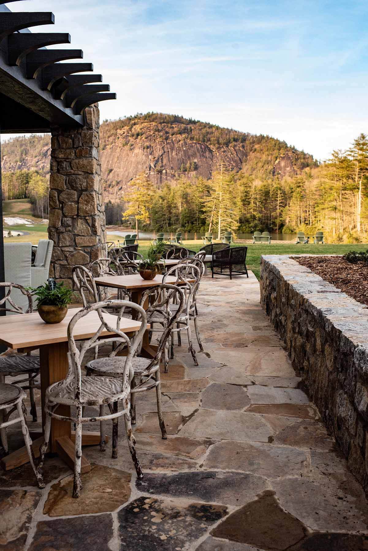 No art on the wall can compete with the natural beauty of Rock Mountain in Cashiers that delights outdoor diners. Image: High Hampton Outdoor patio overlooking nearby mountains at The Dining Room at High Hampton