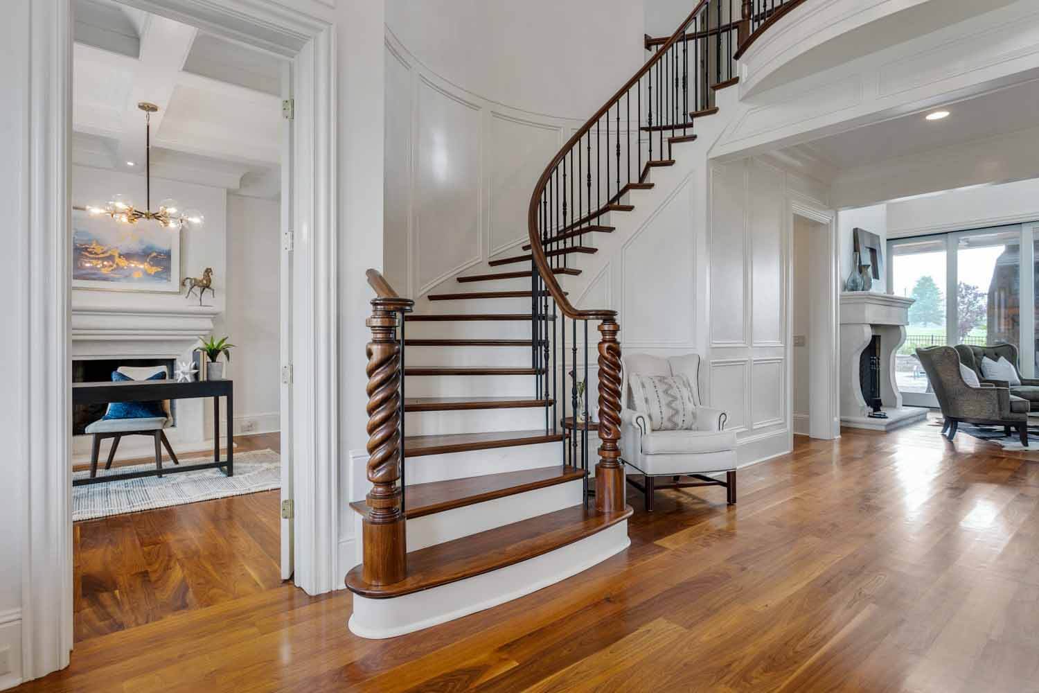 Grand staircase in foyer of a home that's for sale