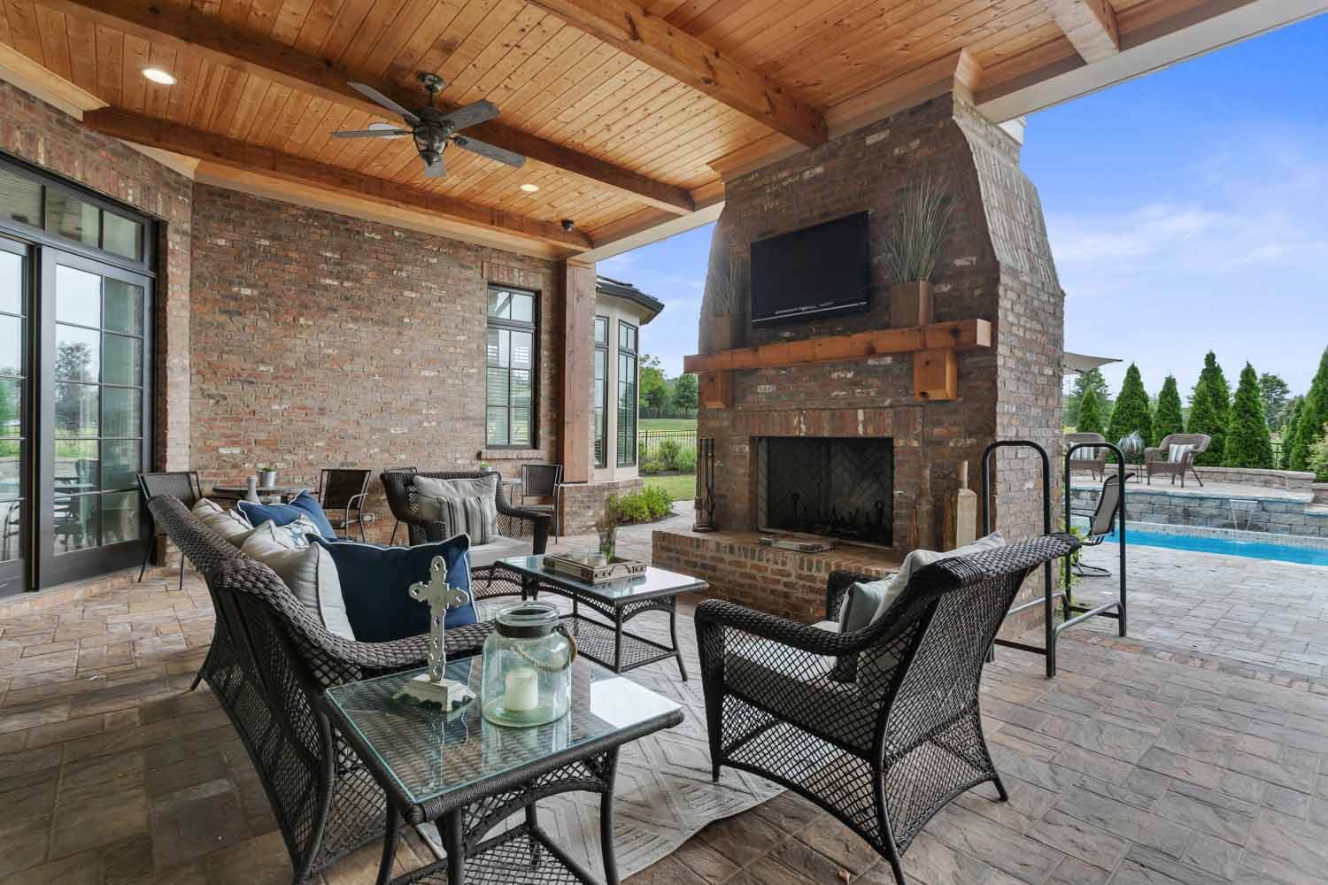Covered outdoor patio overlooking backyard pool