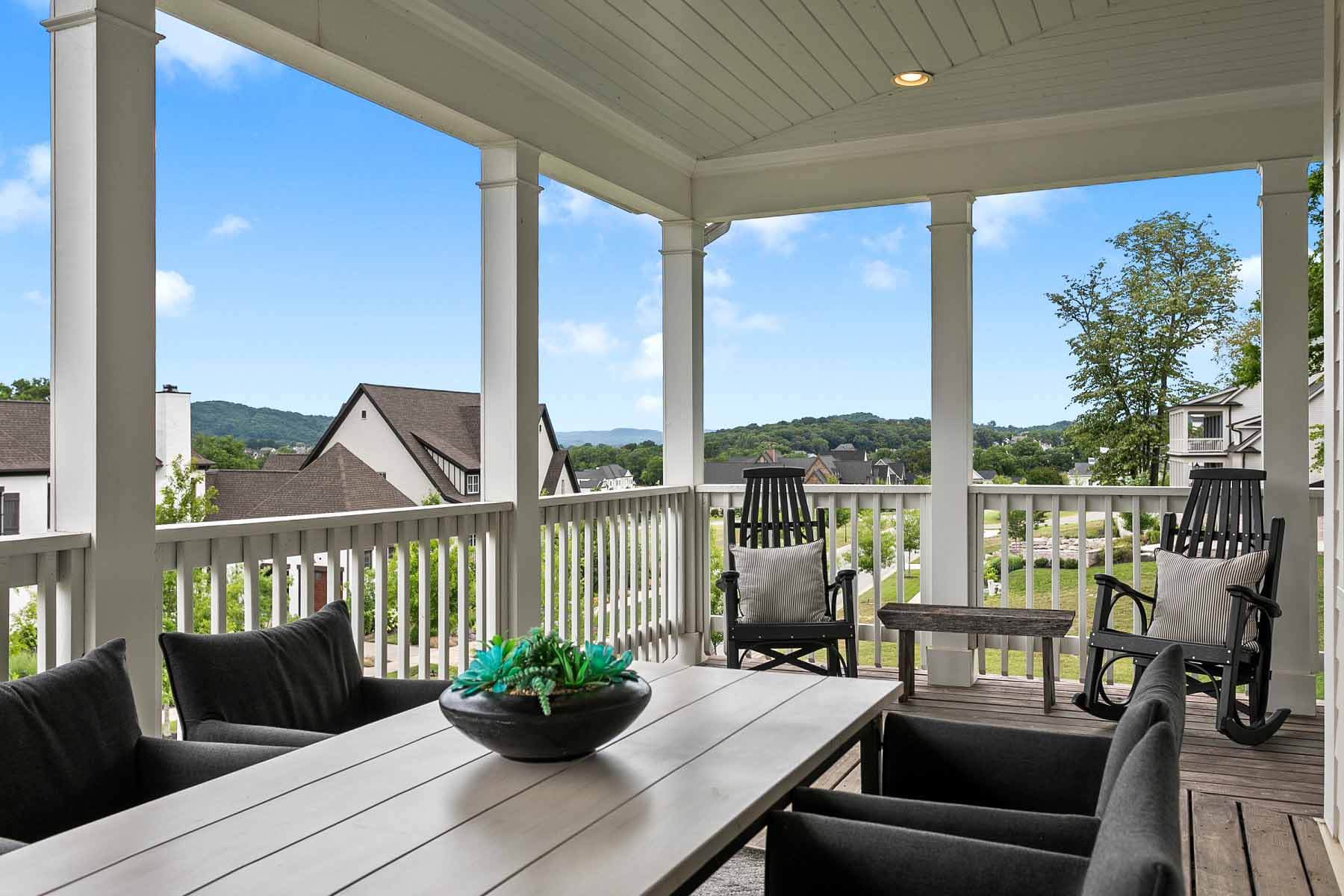 Second-floor wraparound porch at College Grove home