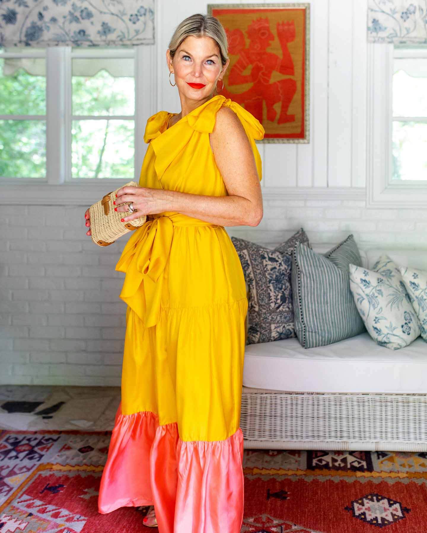 Gen Sohr wearing a yellow dress with salmon-colored ruffle at the bottom