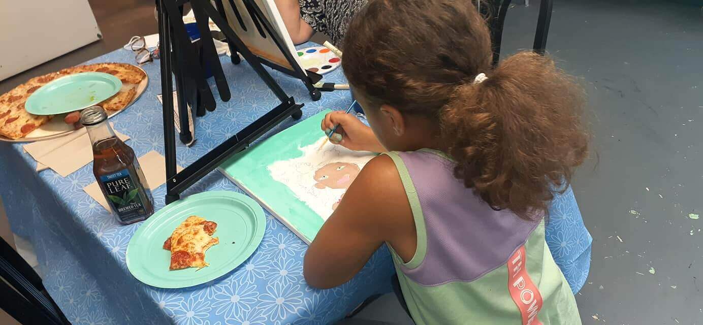 Young girl painting at Minnies Pizza & Paint Shop