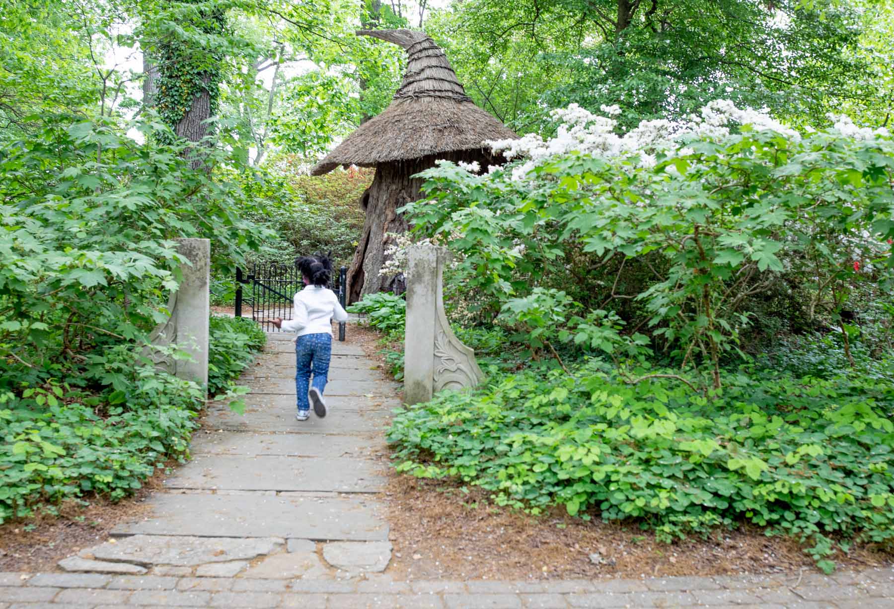 Young girl running through the garden at Winterthur