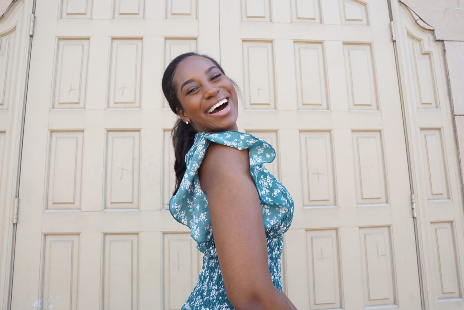 Kameron Monet smiling in floral dress