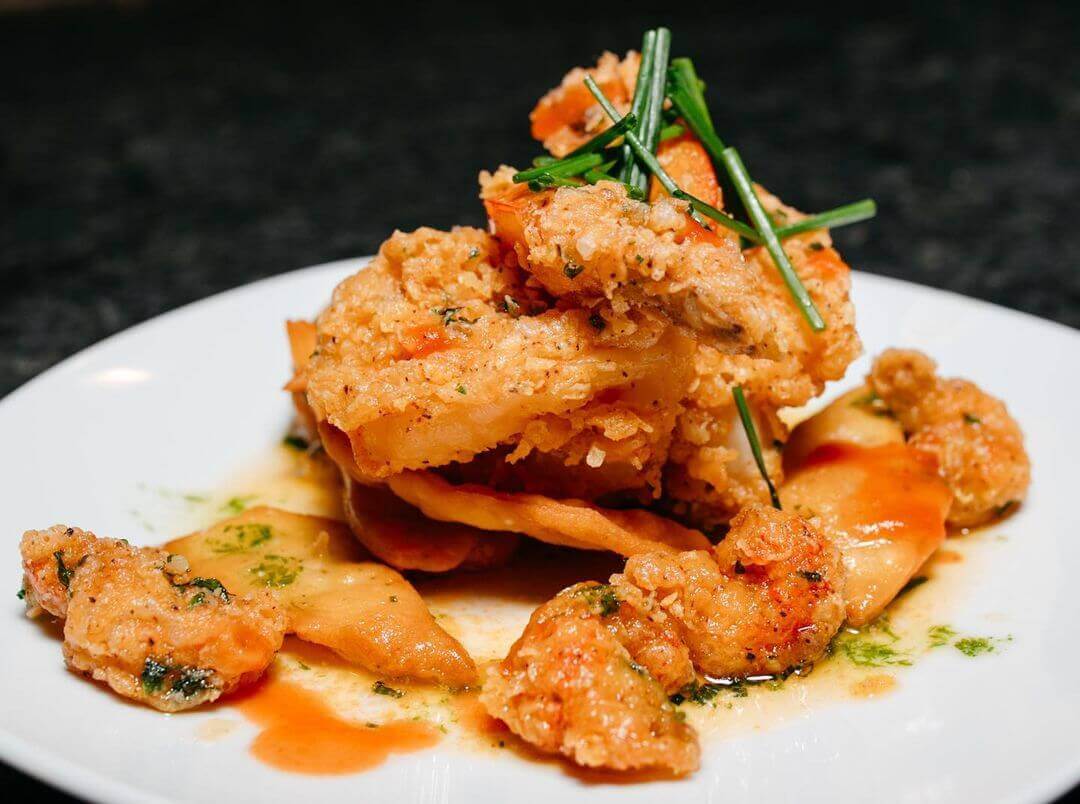 This dish of crispy fried shrimp, crawfish, and dumplings with hot butter sauce from EG + Mc is simply mouthwatering. Image: Instagram Fried shrimp and crawfish from EG + Mc