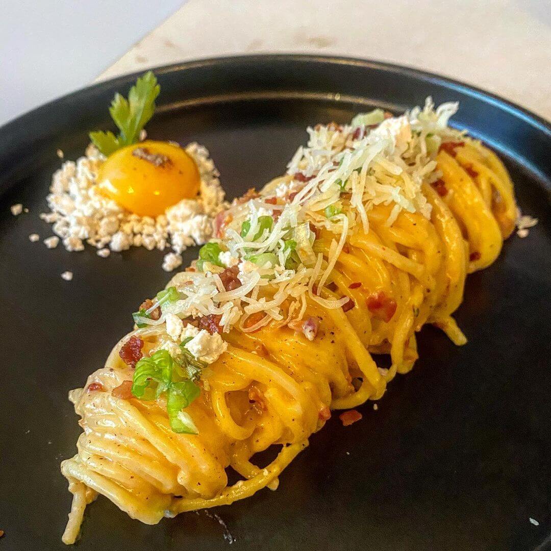 Smoked gouda carbonara with candied bacon sprinkles and bacon fat powder from Phantom Café Modern Eatery & Catering Co.