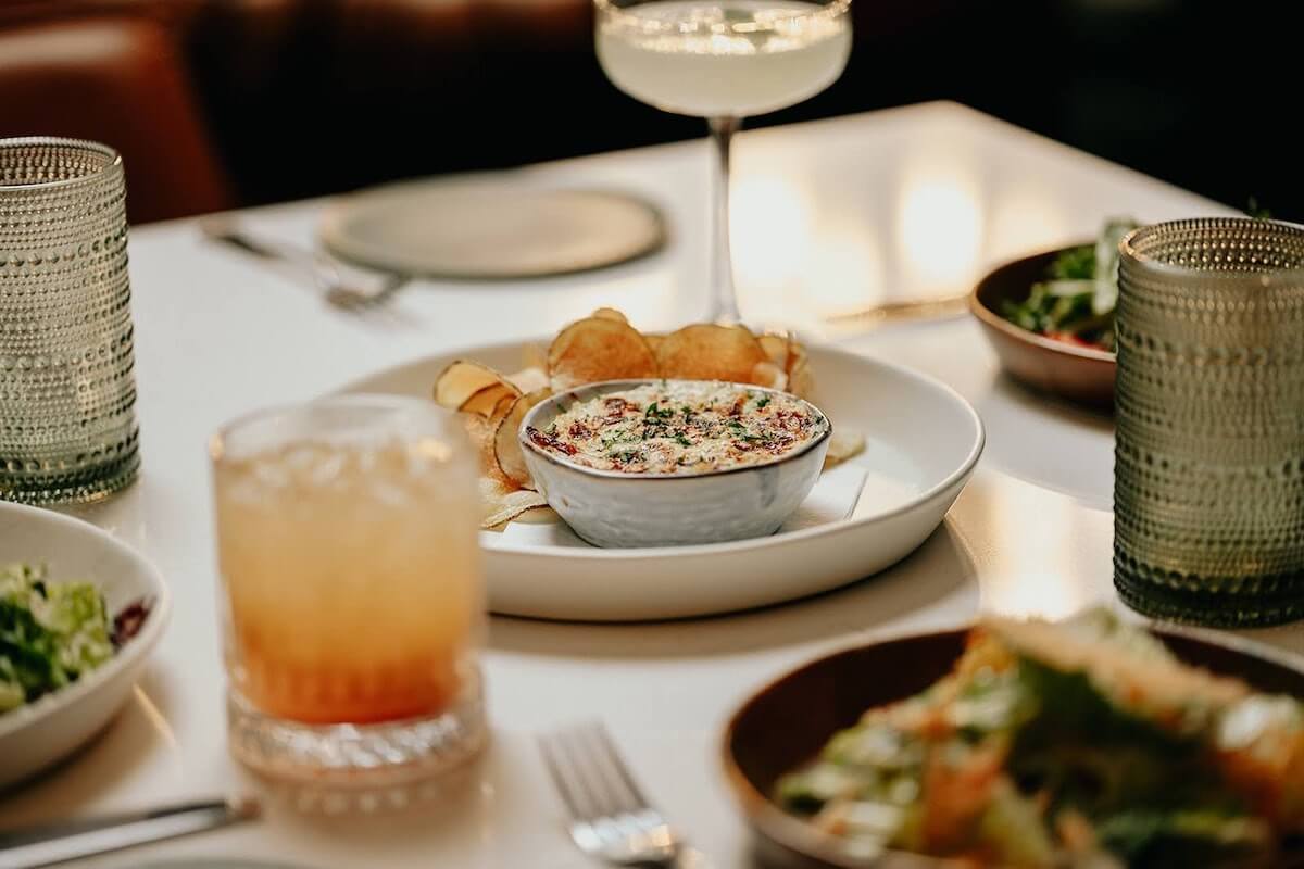 Enjoy fine dining at Limelight. Image: Facebook Cocktails with tasty dishes on a table