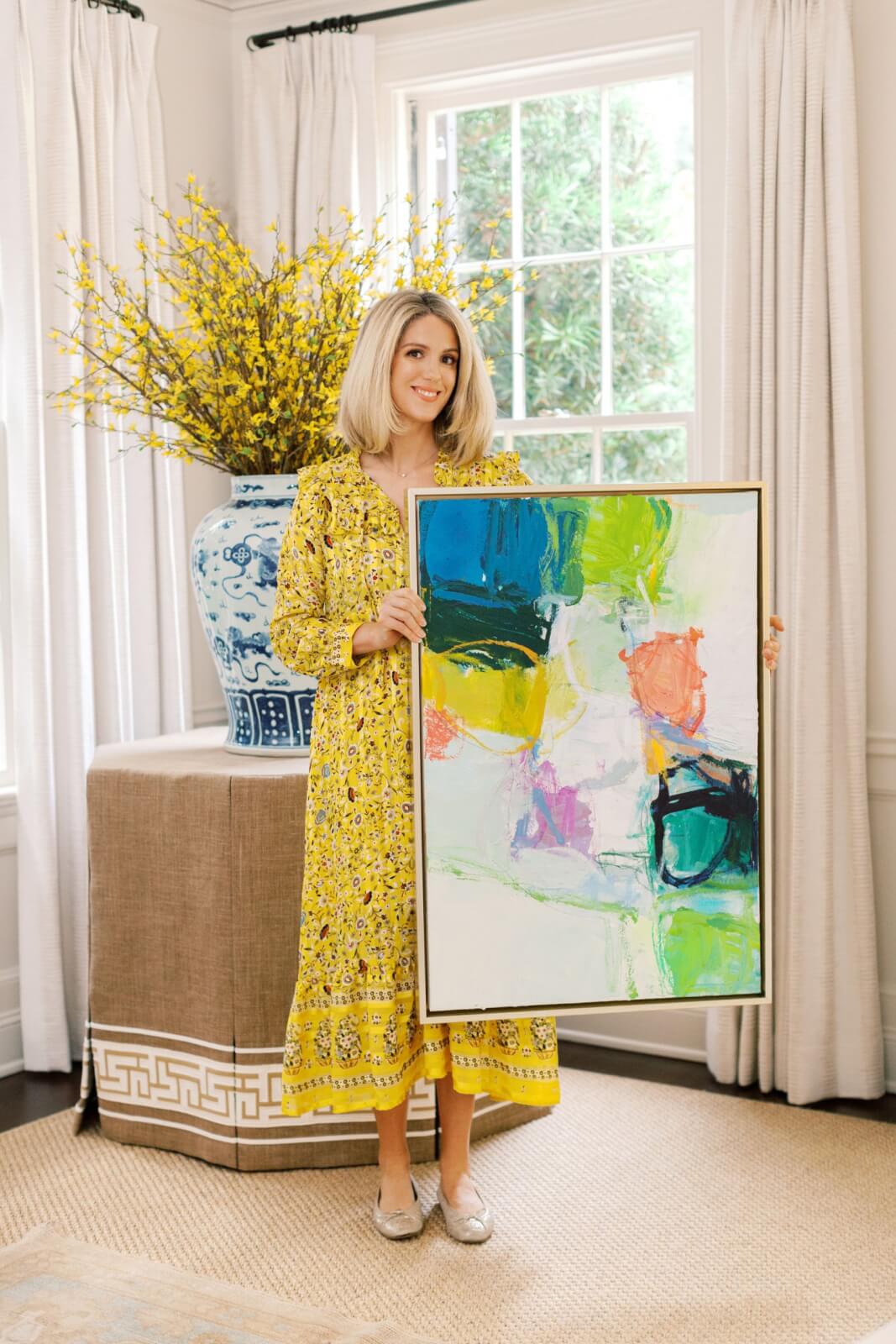 Erin posing with one of her abstract paintings