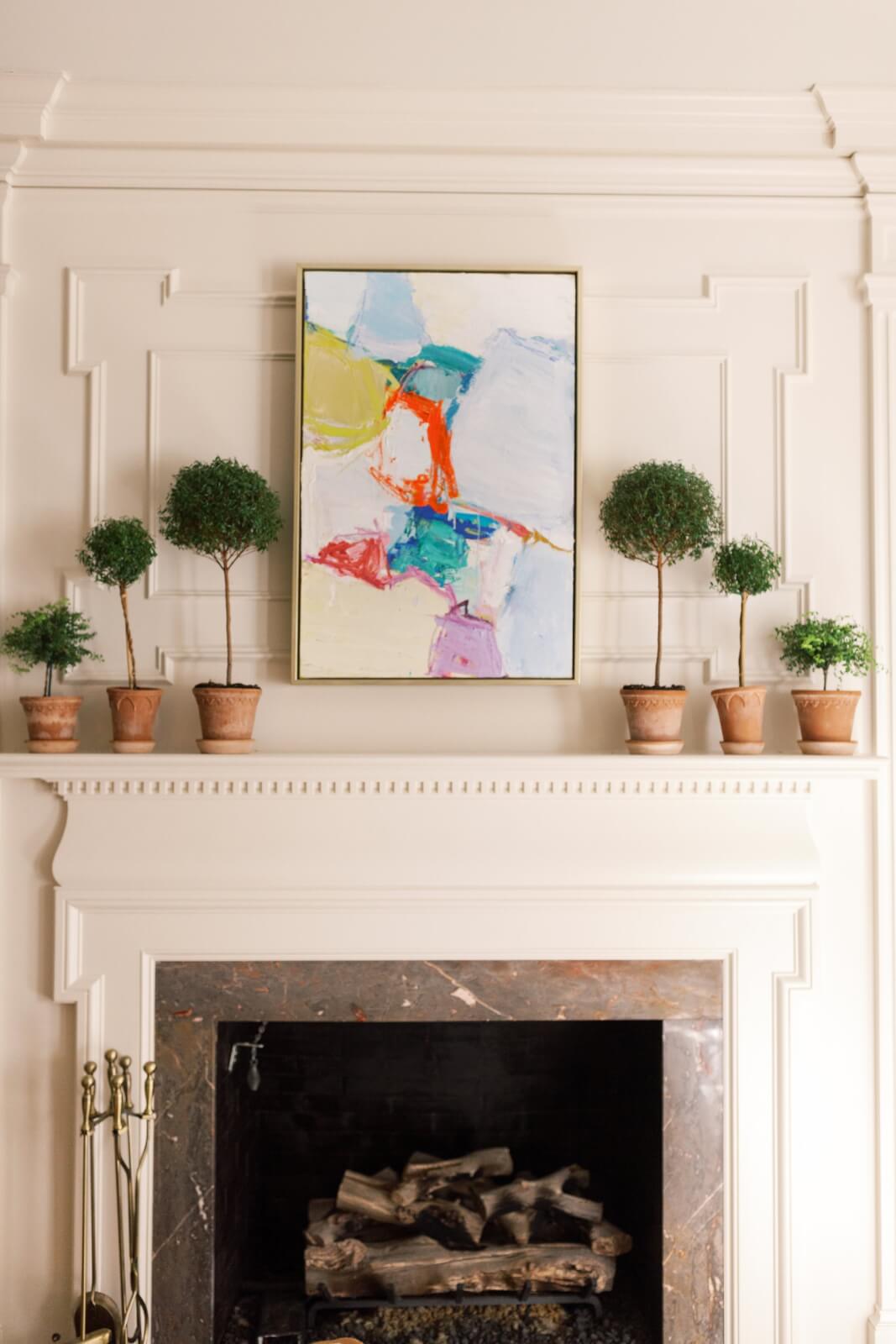 Abstract artwork hanging above a fireplace