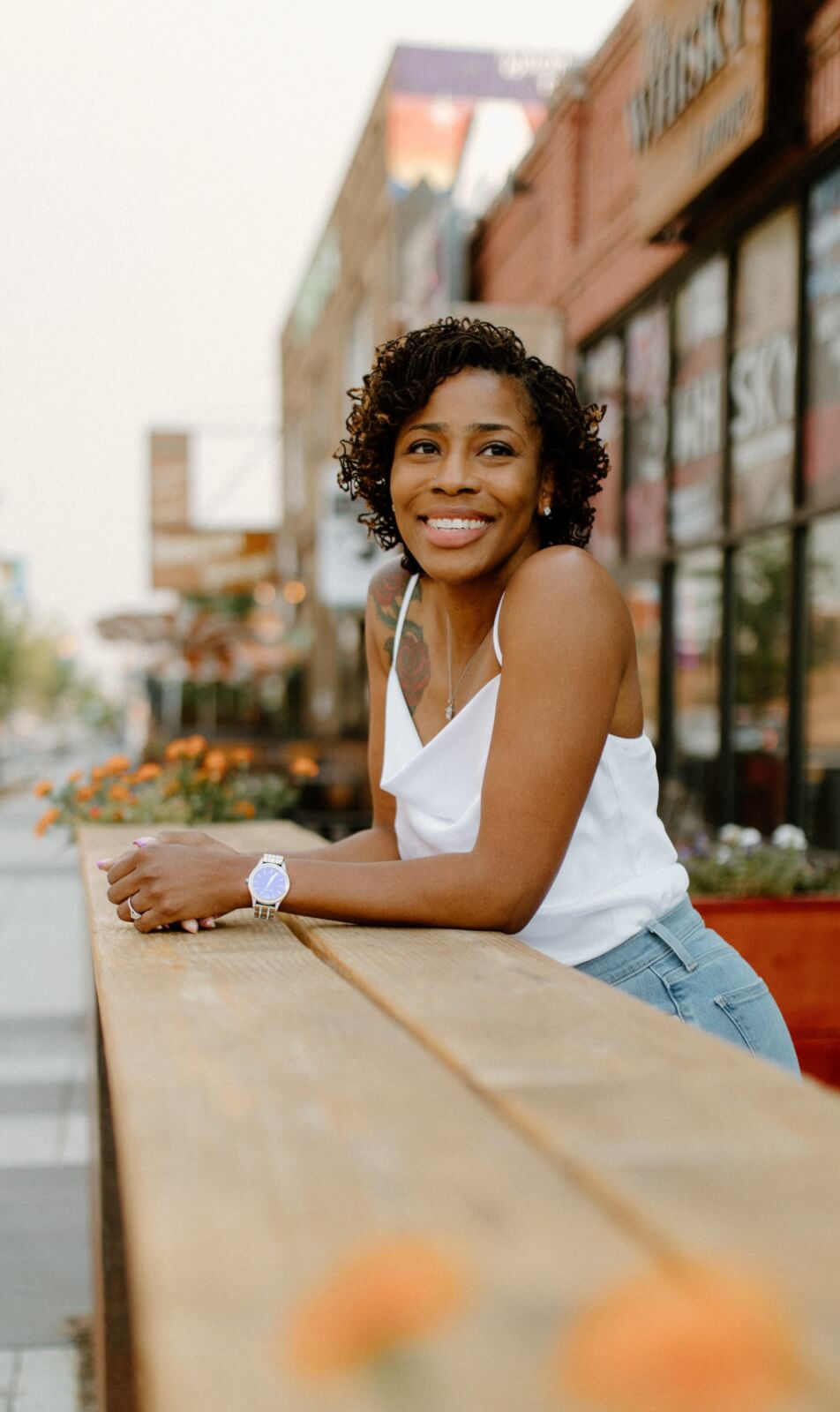 Dr. Sherilyn Garner leaning against outdoor table