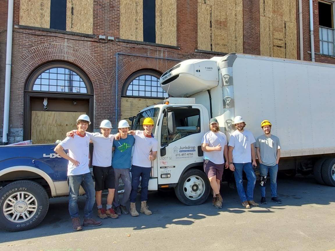 Junkdrop team posing in front of truck