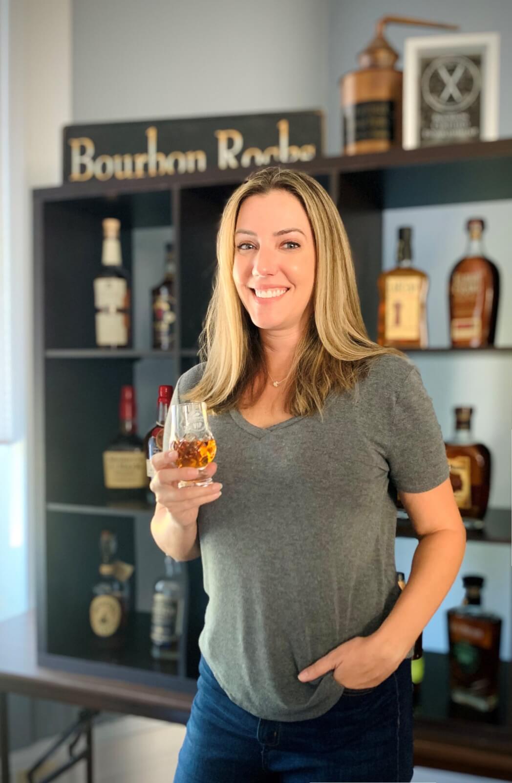 Jennifer posing with a glass of bourbon