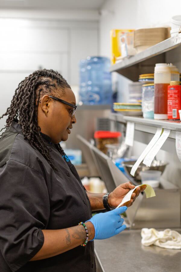 Star Maye in the Anzie Blue kitchen, looking at an order ticket