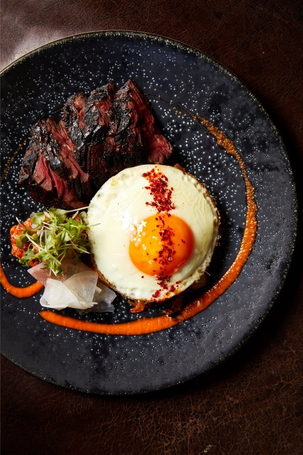 This beautifully plated grilled hanger steak with kimchi fried rice and a fresh farm egg is calling our name. Image: Rachel Vanni A beautifully crafted dish from The Dutch, with a poached egg.