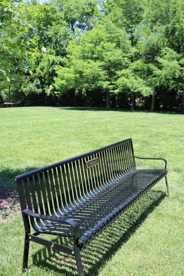 A friendship bench in the open green space at Homestead Manor.