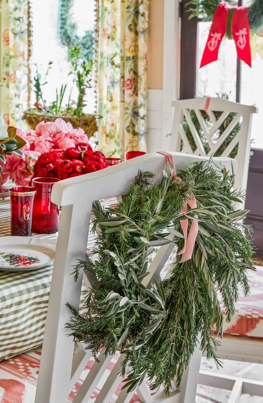 A rosemary and bay leaf wreath on the back of a dining chair.