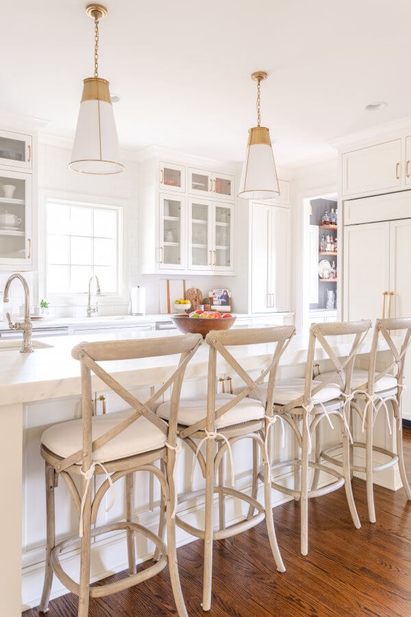 A close-up view of the kitchen island with stools, designed by Van Mol Restoration.