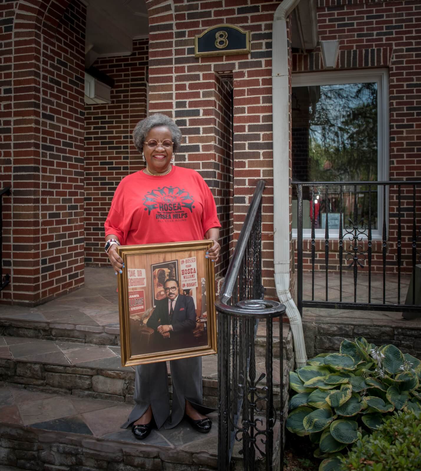 Elizabeth holding photo of her father Hosea Williams