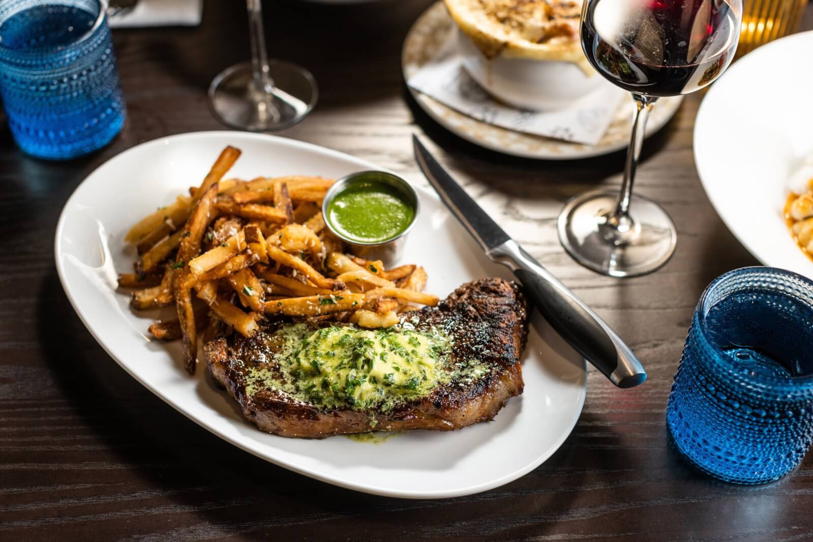 Steak frites and glass of red wine from Toussaint Brasserie, a new Southern restaurant