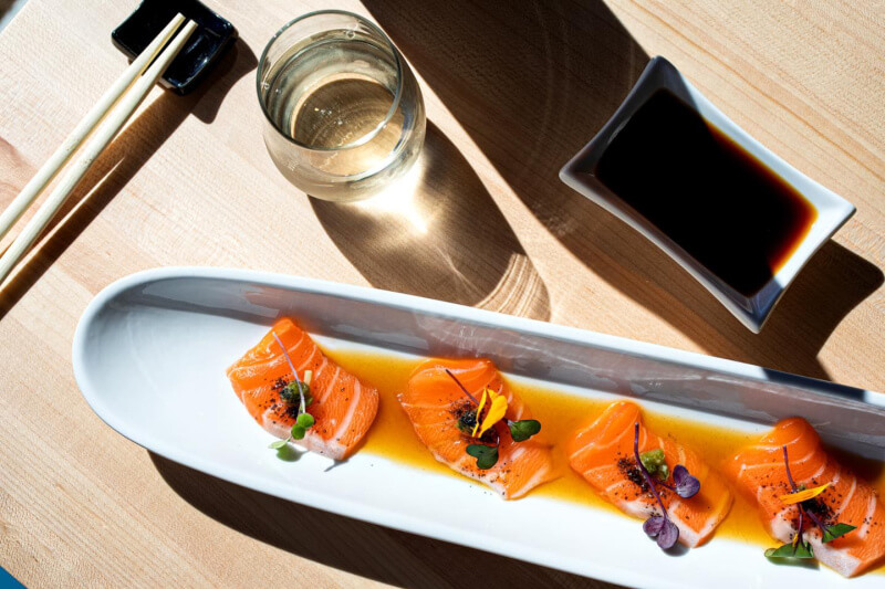 White oval platter of salmon sashimi
