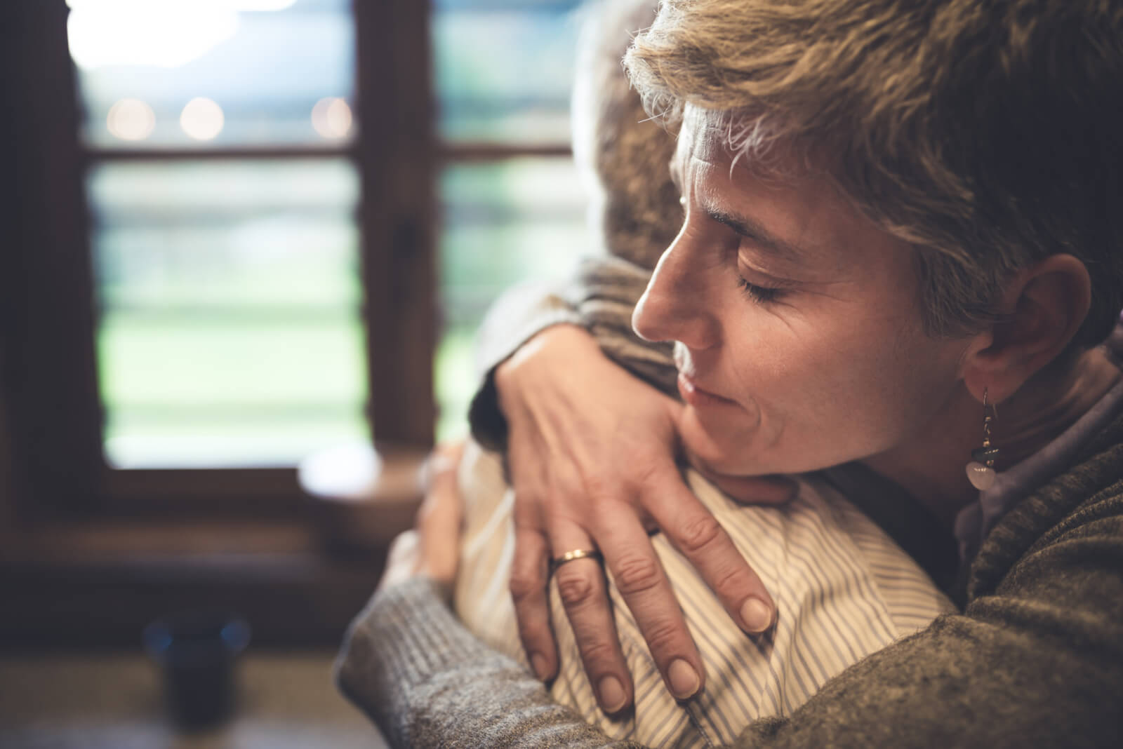 older woman embraces friend