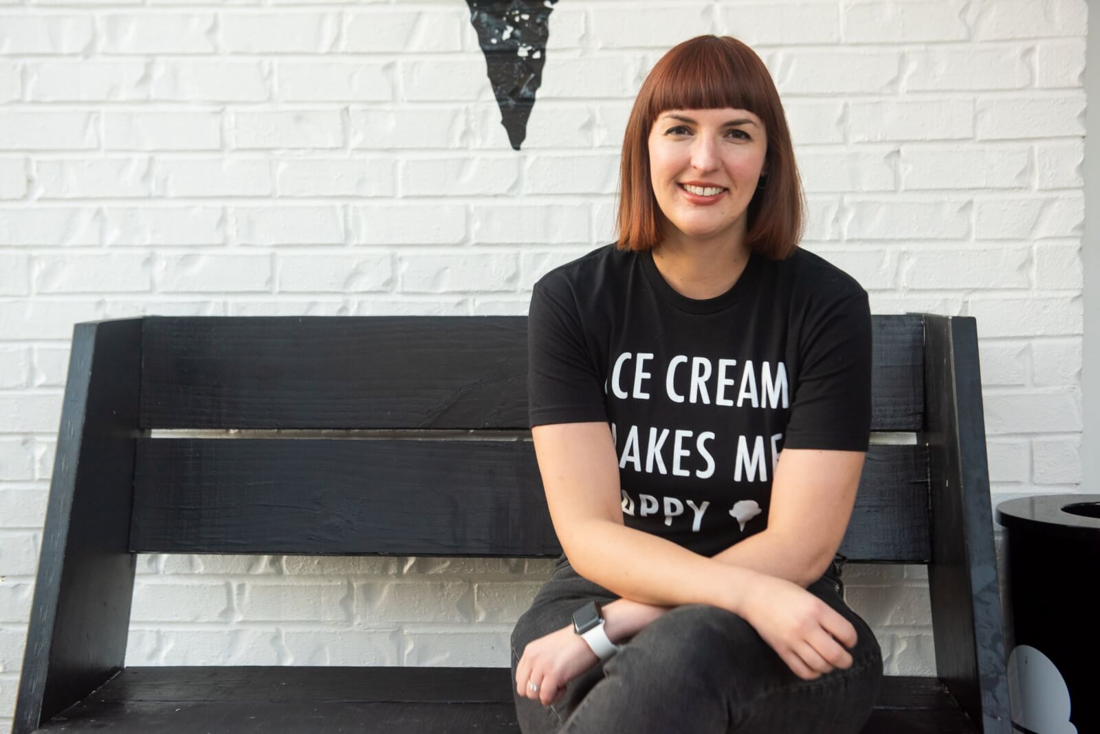 Claire Crowell on a bench, in an "Ice Cream Makes Me Happy" T-shirt.
