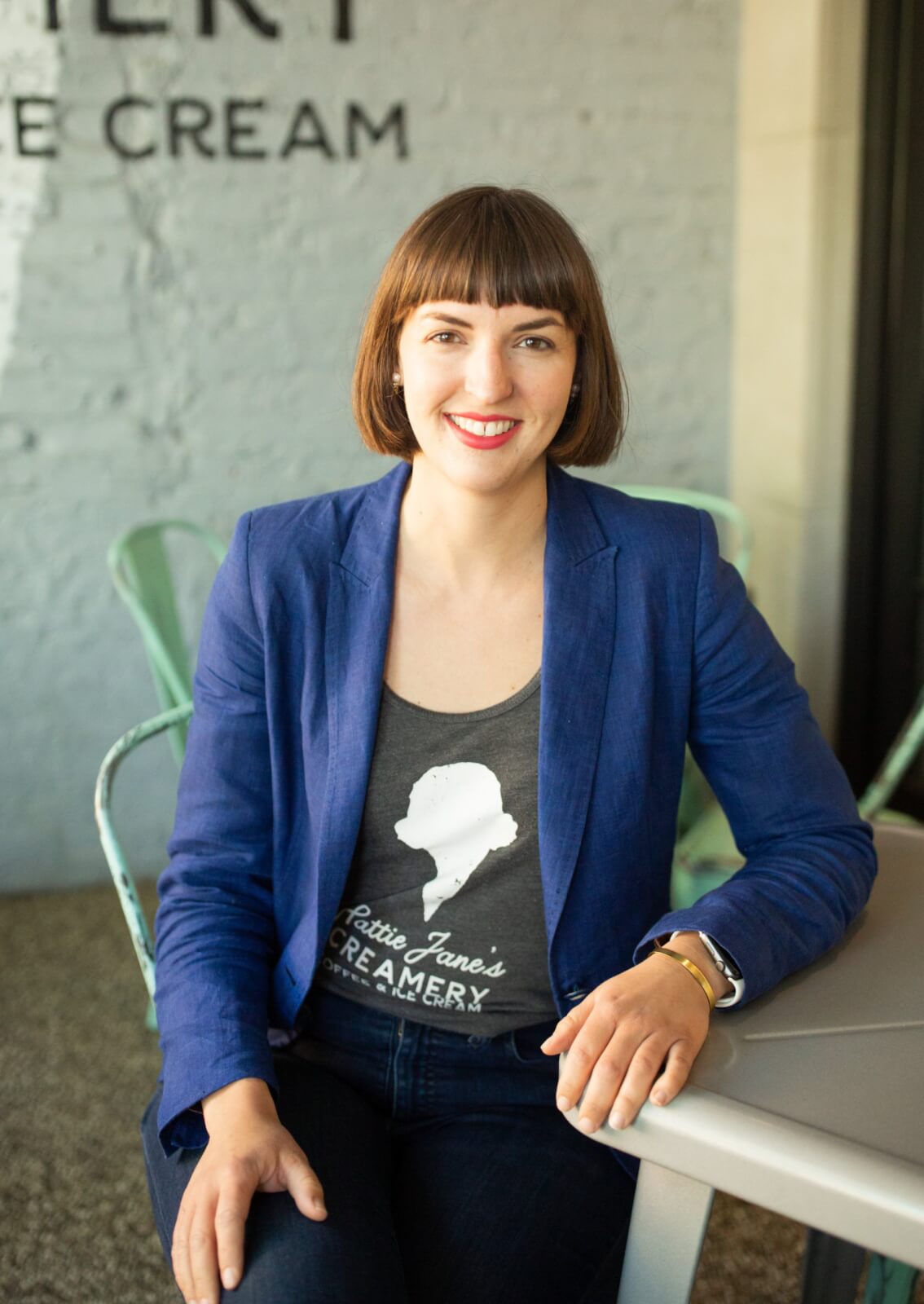 Claire in a blue jacket and Hattie Jane's Creamery shirt.
