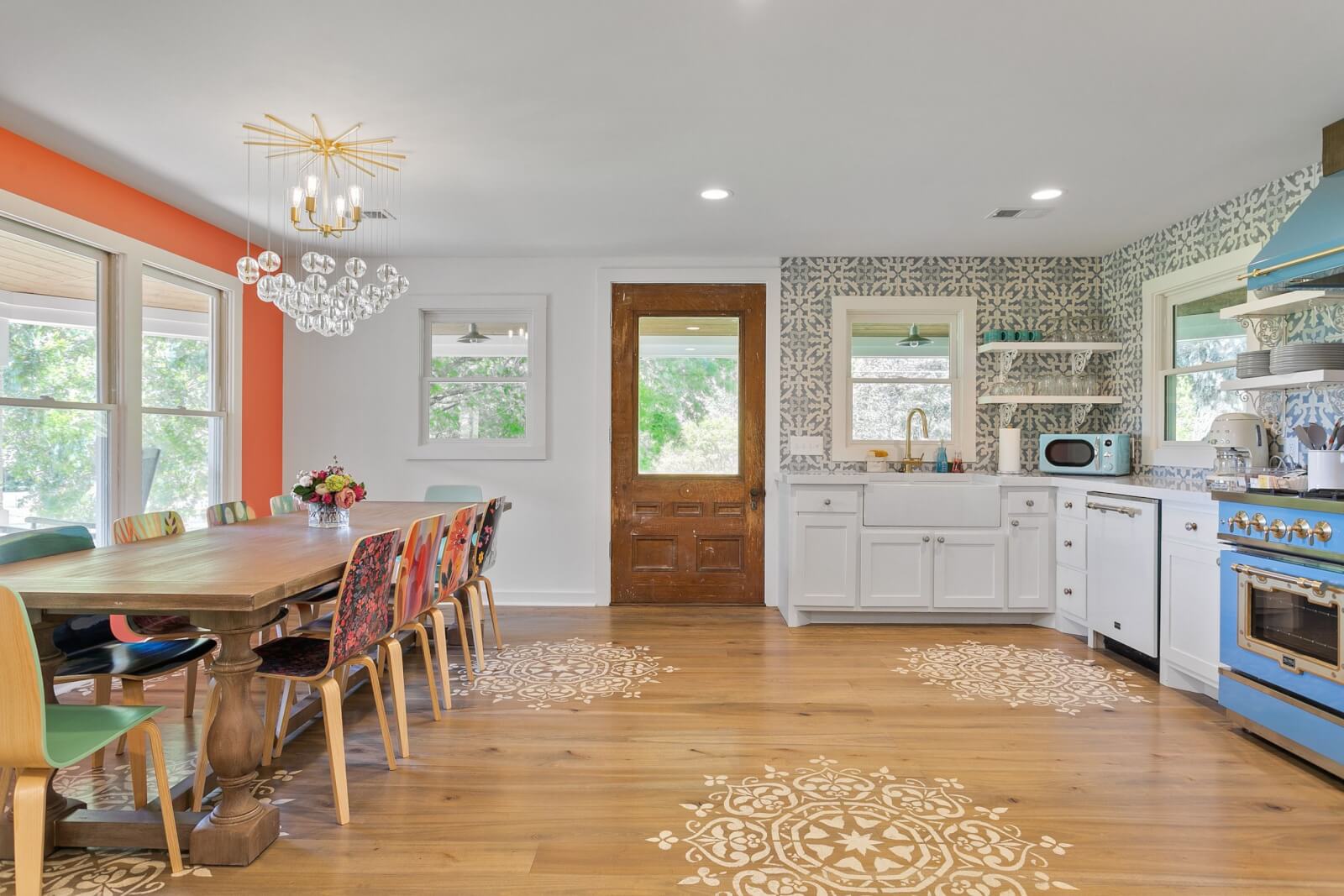 Colorful kitchen with blue stove and range and long dining room table