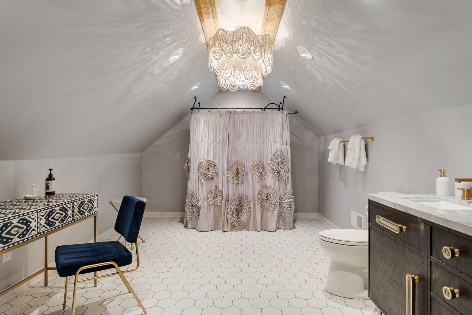 Elegant upstairs master bathroom with a vanity and clawfoot tub