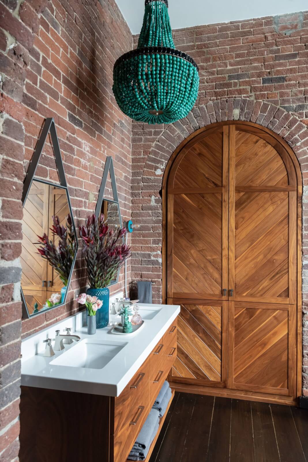 Primary bathroom with custom wood doors leading to closet