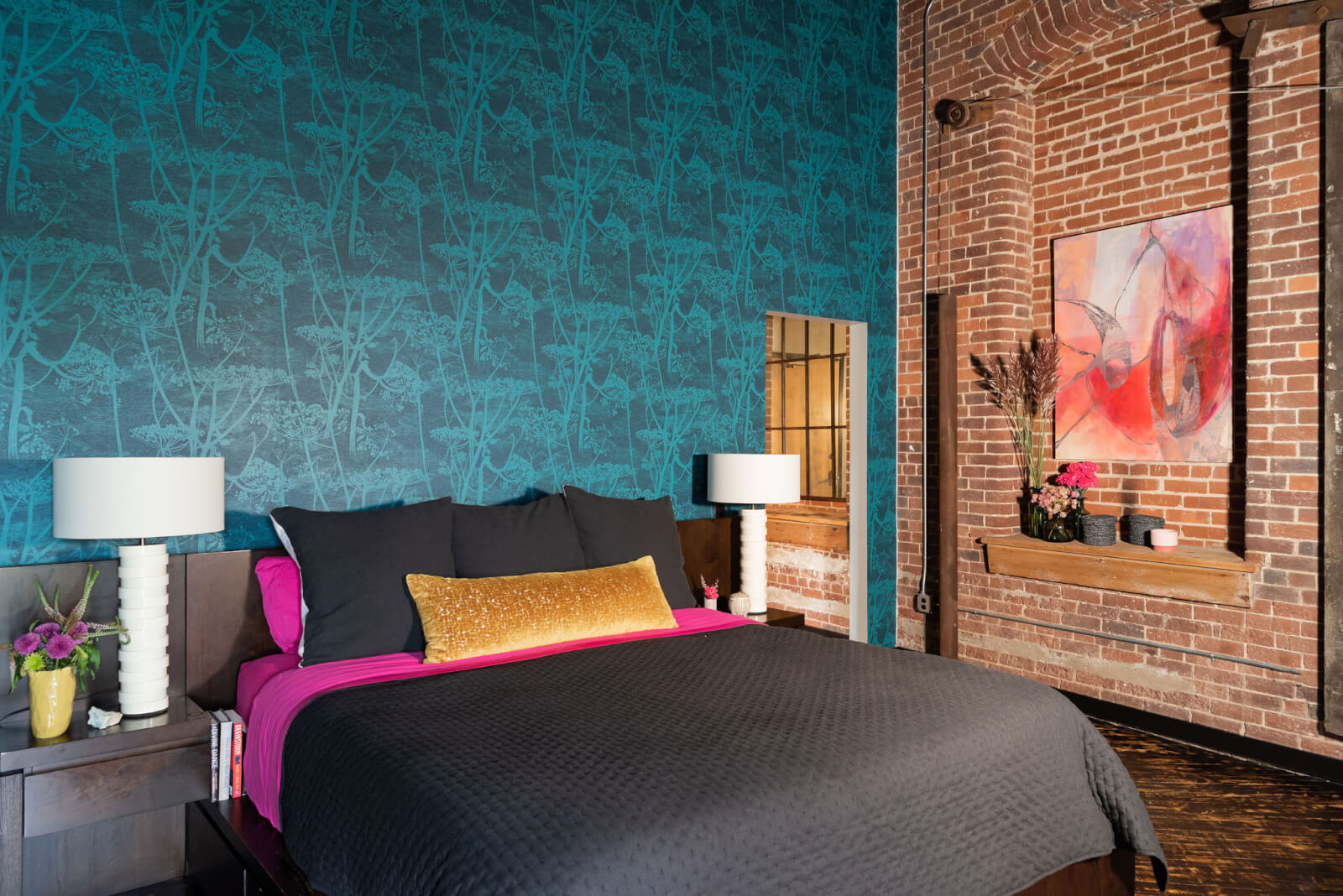 Bedroom with brick wall and blue wallpapered wall