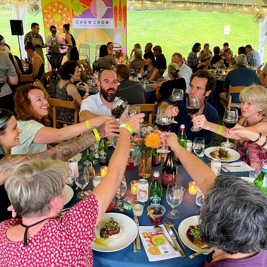 Cheers at table at culinary festival Chow Chow