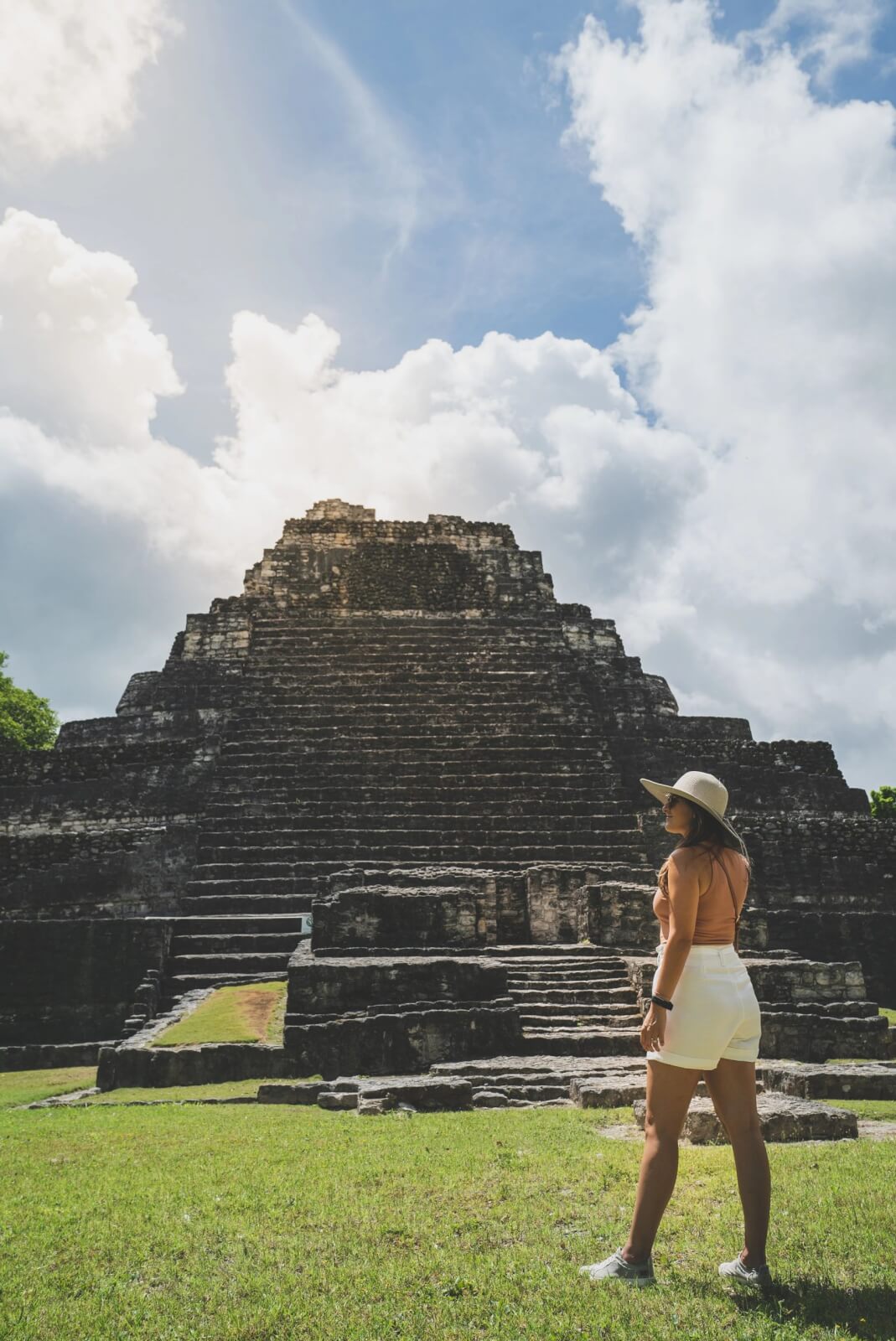 Woman looking at the pre-Columbian Mayan ruins of Kohunlich