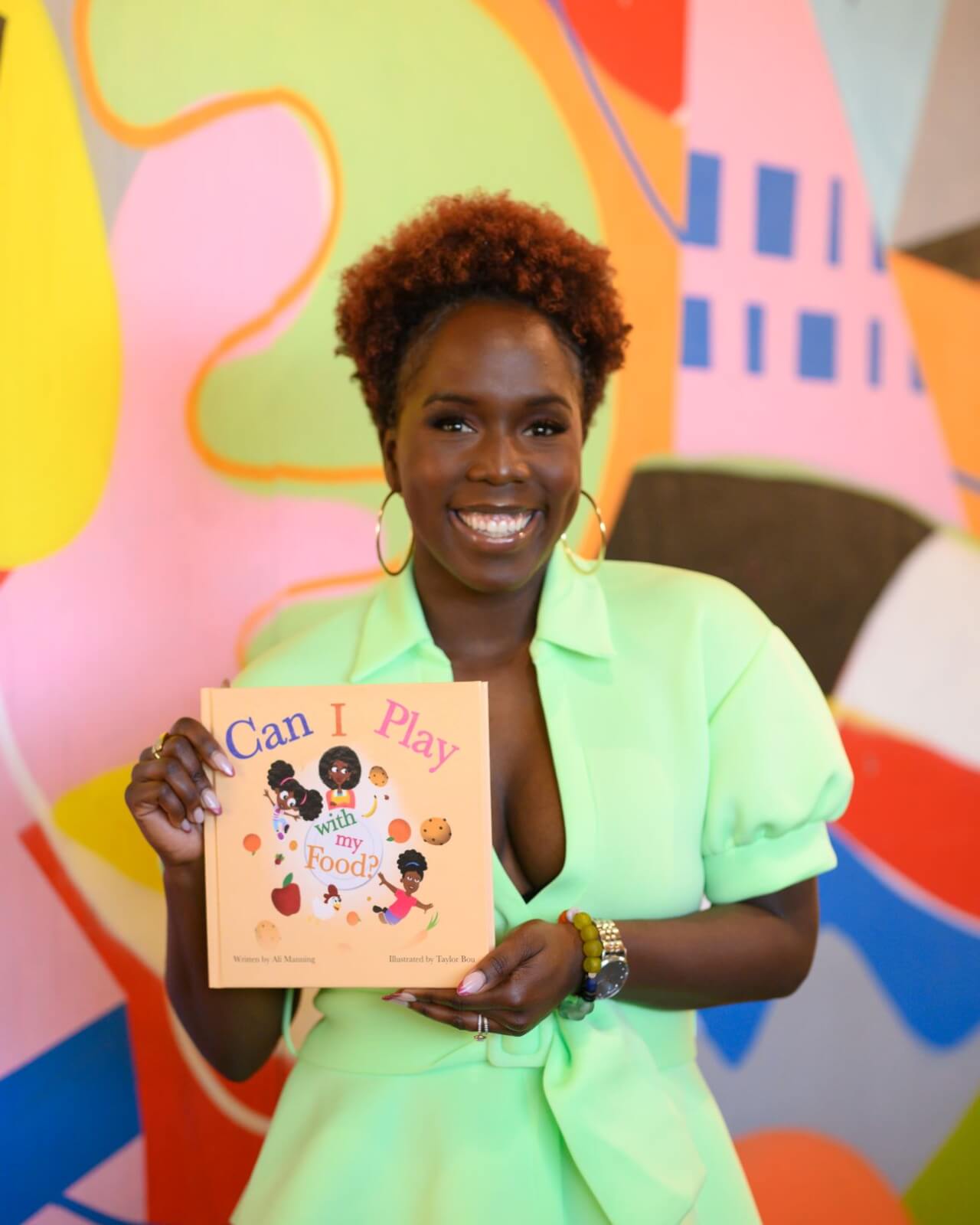 Ali Manning of Umami Food Consulting holding her book "Can I Play With My Food?"