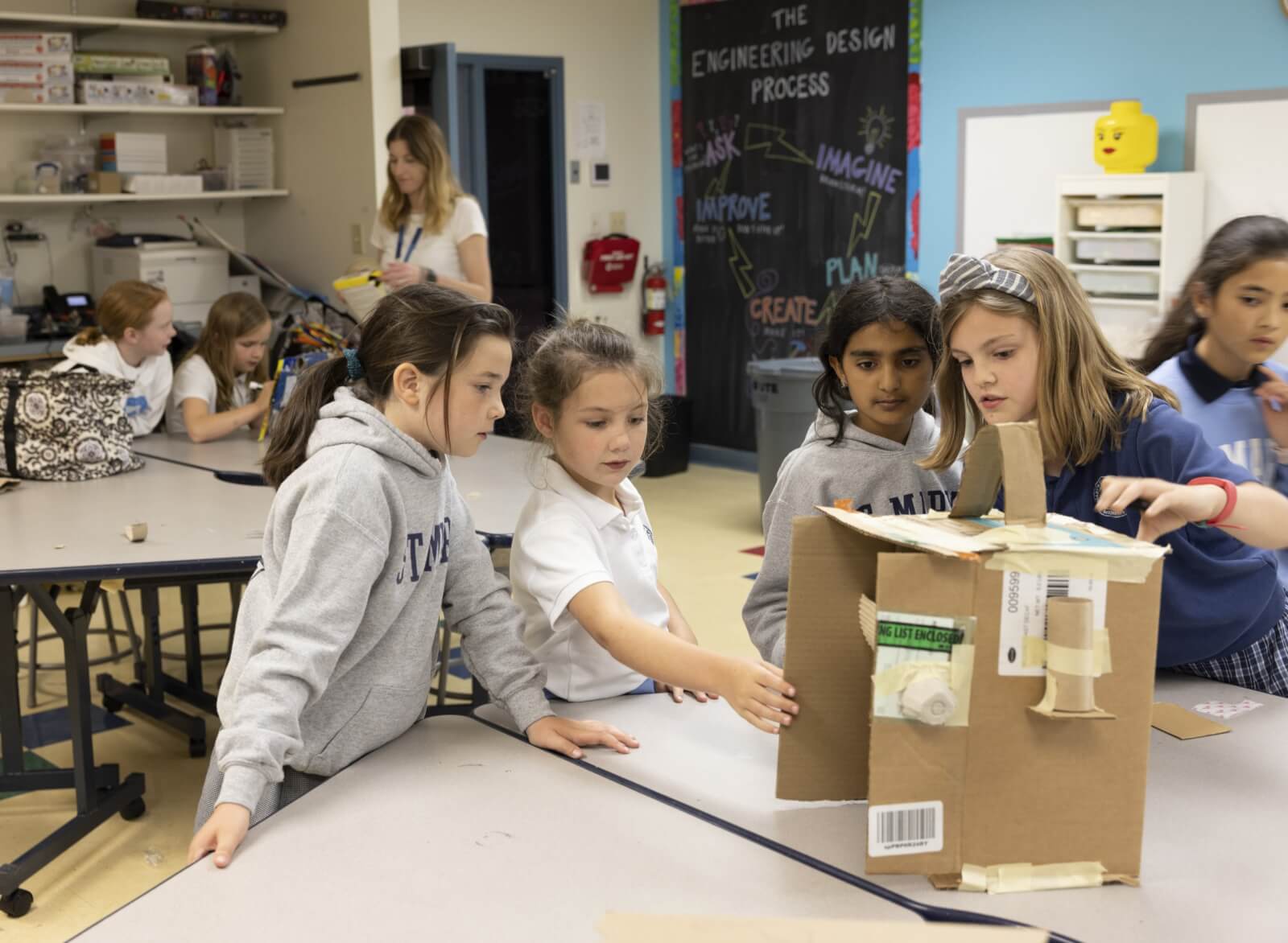 St. Mary's students using cardboard to build something that would help someone else