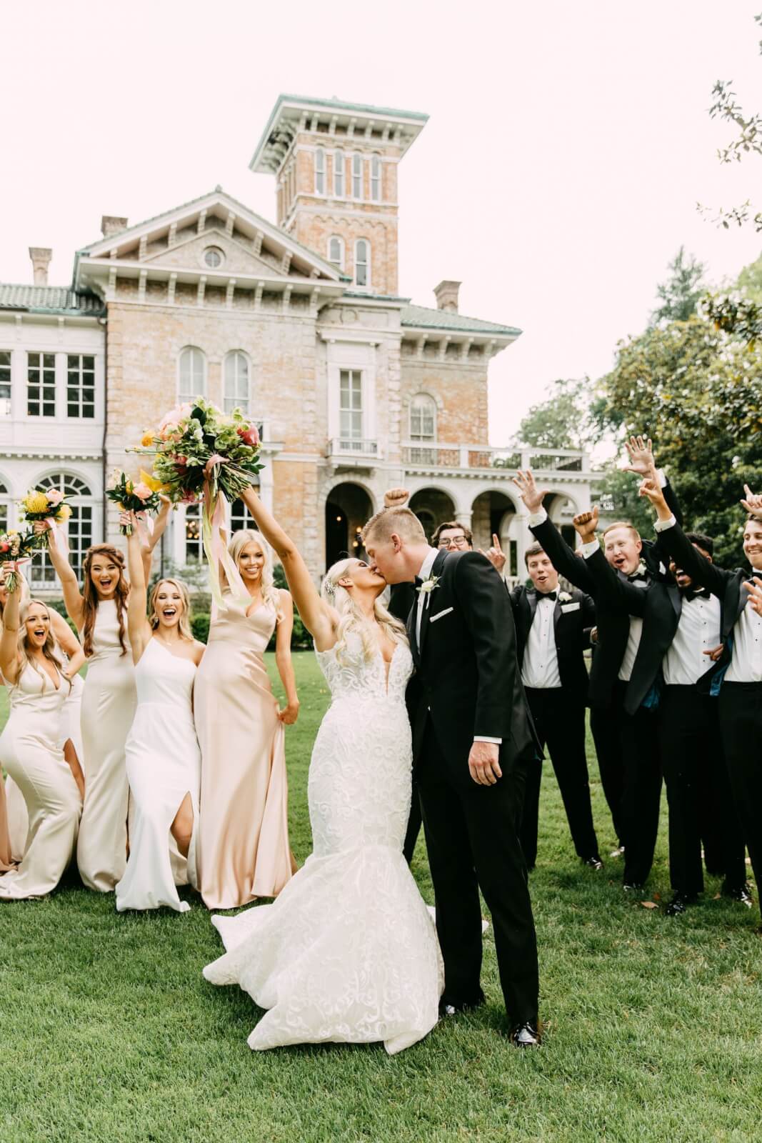 Bride, groom, and bridal party celebrating outside Annesdale Mansion