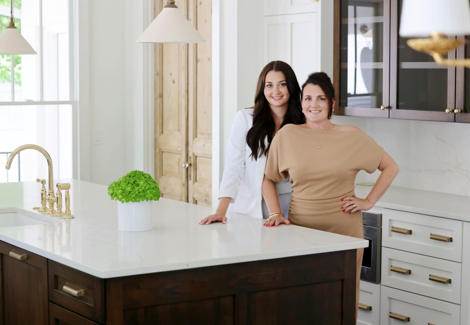 The ladies pose in the kitchen of the 1920s craftsman home