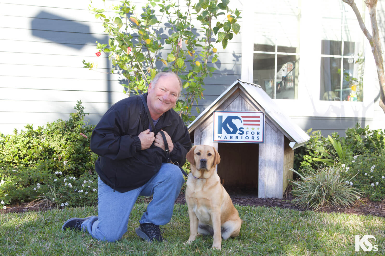military veteran poses with dog