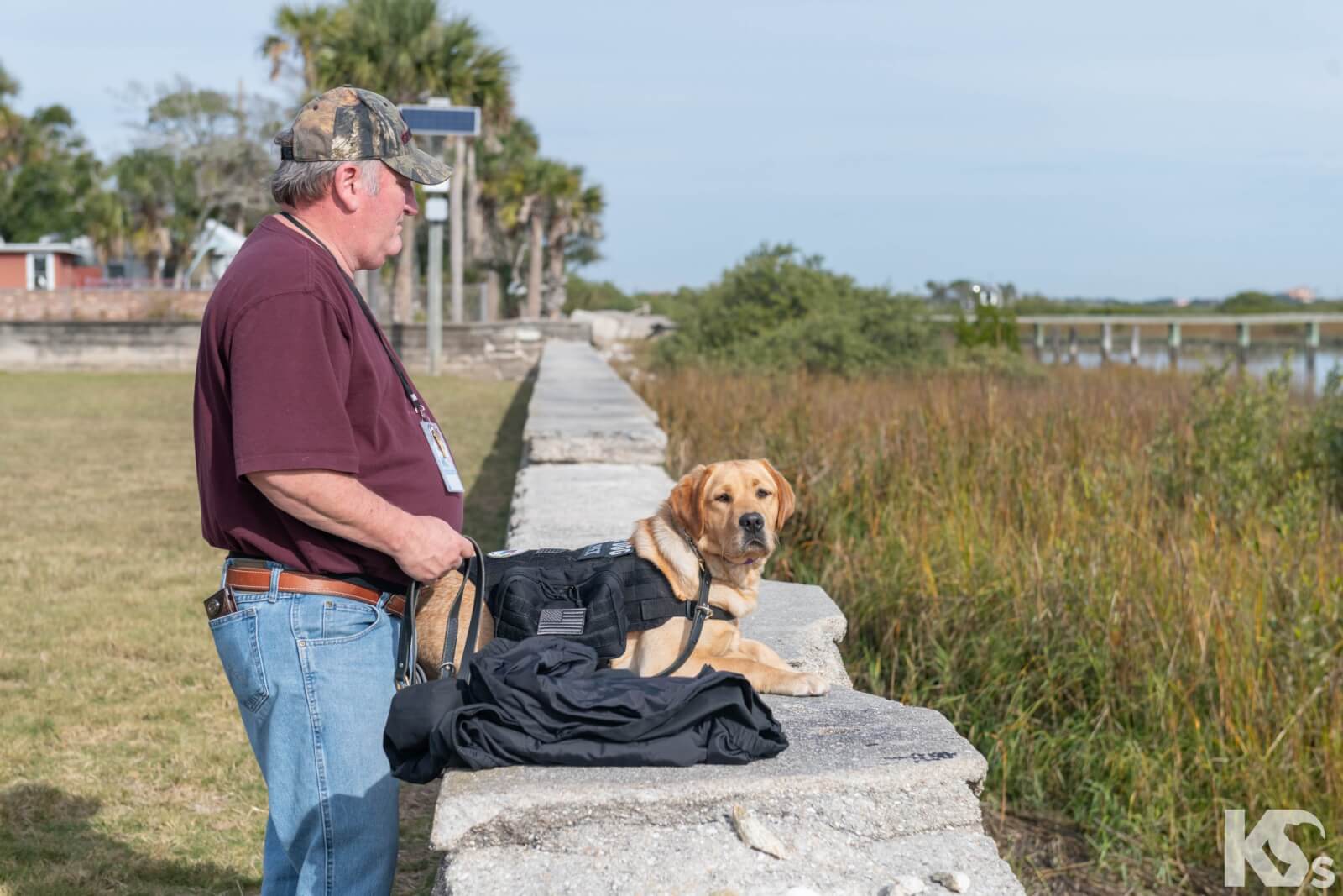 Kenneth with his dog, Spirit, looking out across the field.