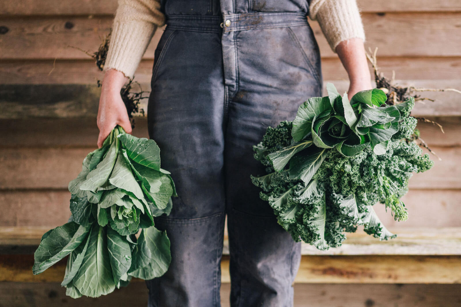 A close-up of Lauren carrying vegetables at the farm