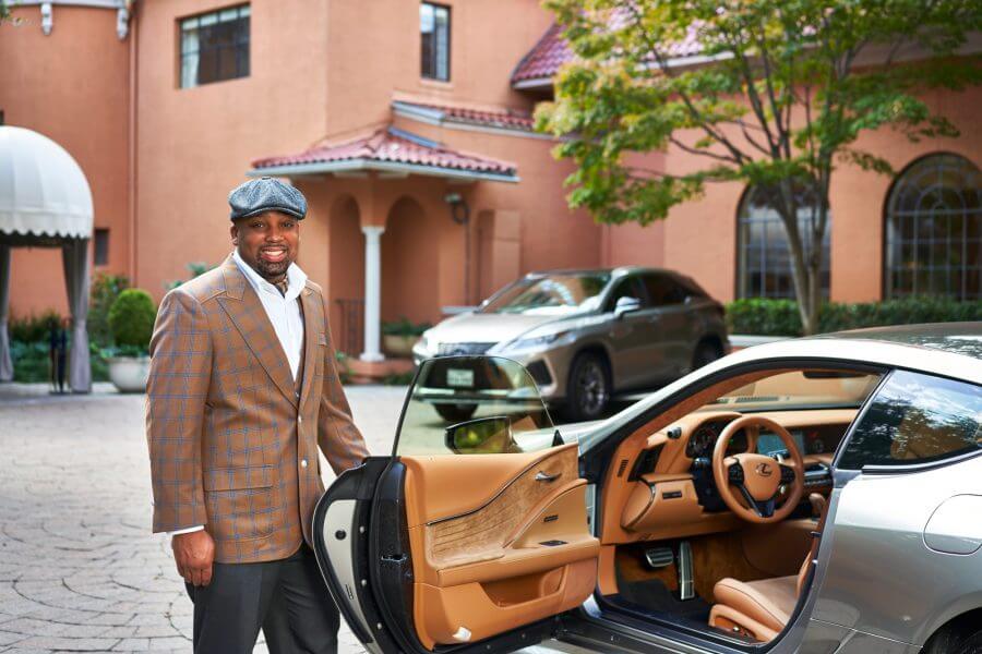 A man standing by a Lexus at Rosewood Mansion in Turtle Creek
