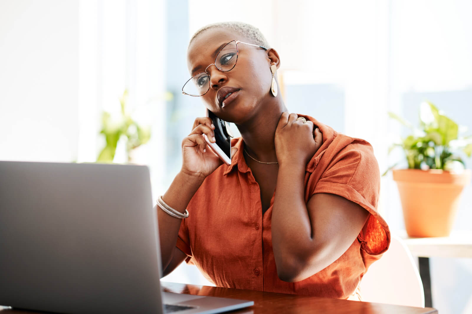 woman on phone looking stressed