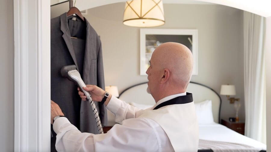 A man steaming a suit for the Butler Service at the Spectator Charleston,