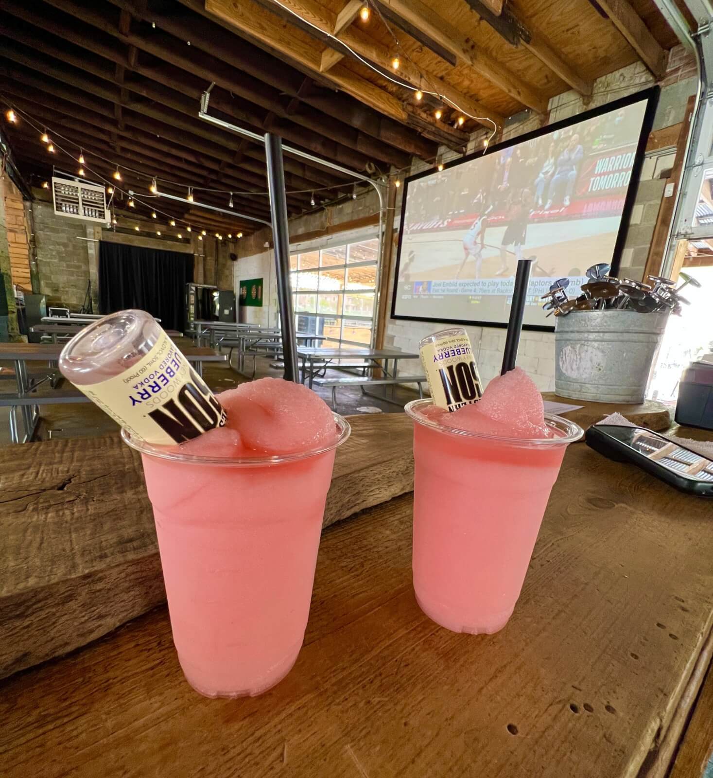 Opt for an extra shot with your frozen cocktail at Loflin Yard if you like a little more booze! Two frozen rosés on the indoor patio of Loflin Yard with an extra shot of blueberry vodka.