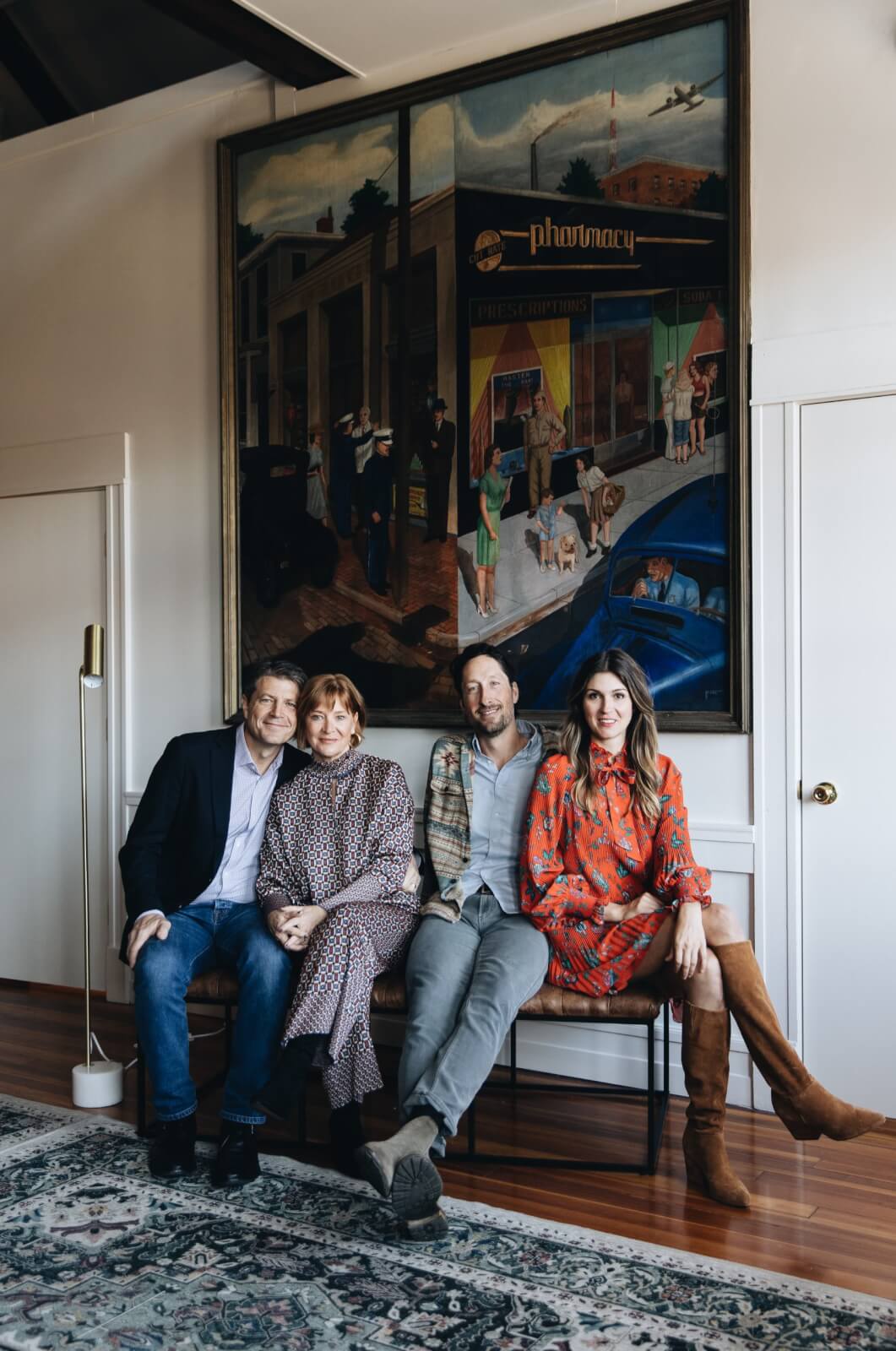 Owners of The Bellwether posing in front of artwork