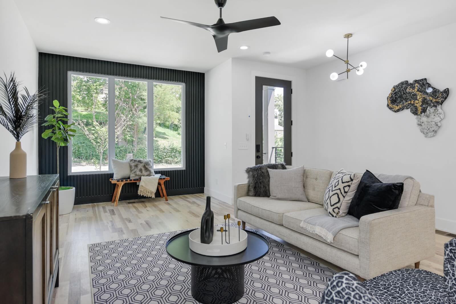 Living room with black accent wall and large picture window