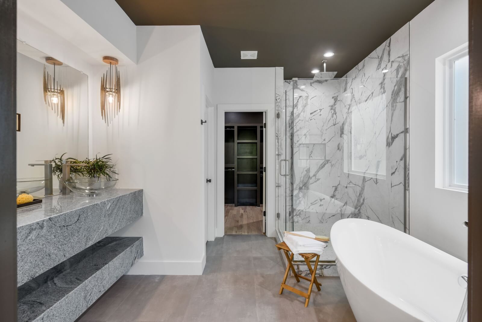 Primary bathroom with freestanding tub and marble shower at 11B Garden Street